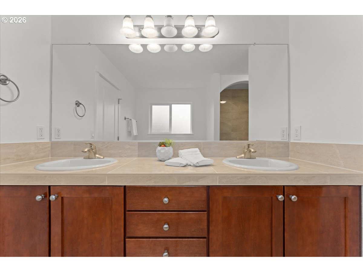 11595 Southwest Butte Lane Beaverton, OR 97008 - Photo 31 of 48 a bathroom with a double vanity sink and a mirror