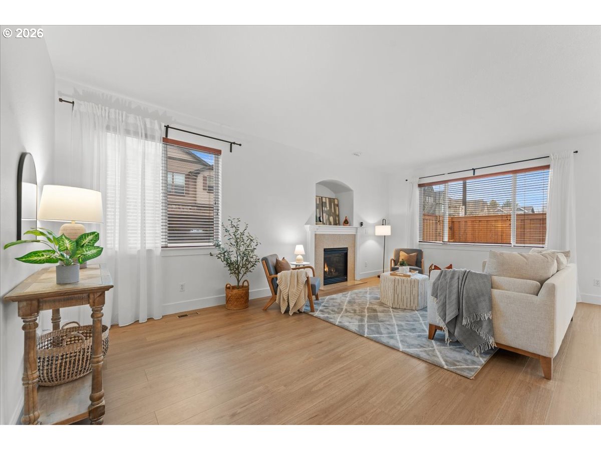 11595 Southwest Butte Lane Beaverton, OR 97008 - Photo 10 of 48 a living room with furniture a fireplace and a window