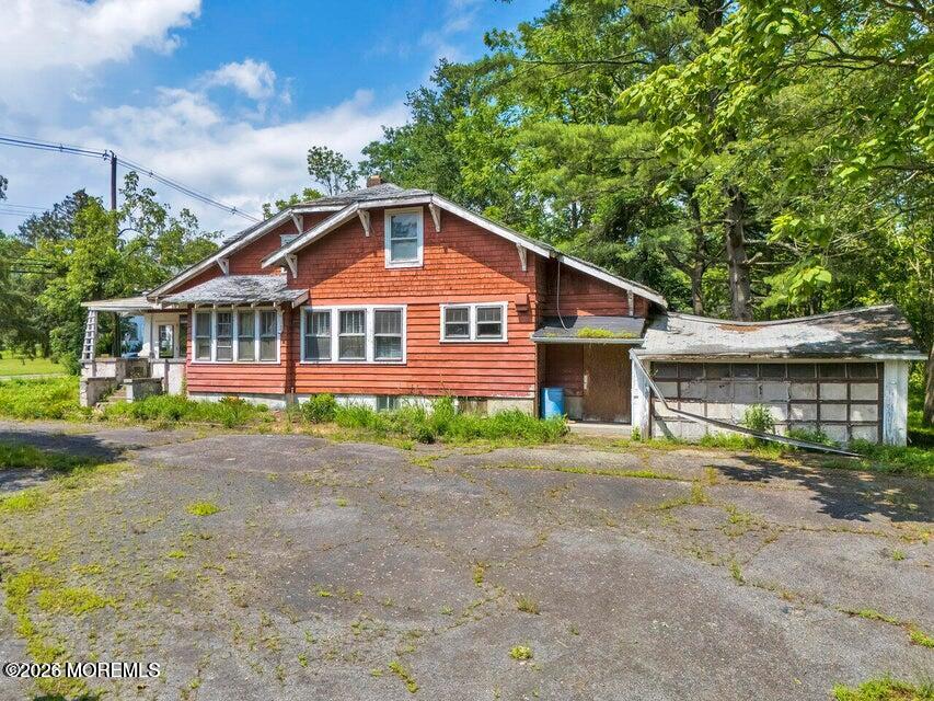 465 Lakewood Farmingdale Road Howell, NJ 07731 - Photo 8 of 19 a front view of a house with a yard and trees
