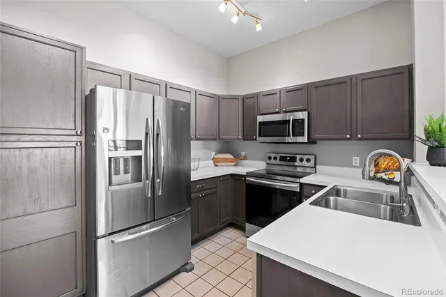 a kitchen with stainless steel appliances and refrigerator