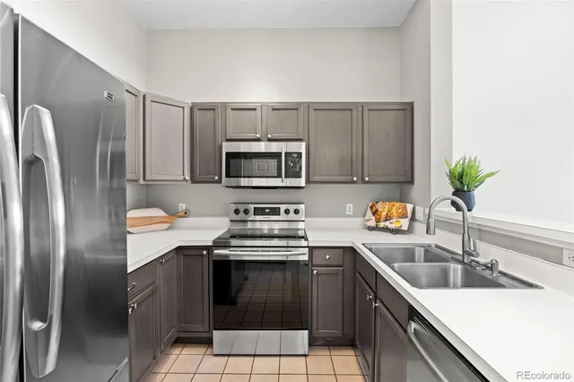 a kitchen with a sink appliances and cabinets