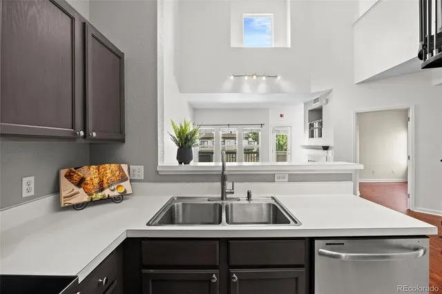 a kitchen with a sink a counter and cabinets
