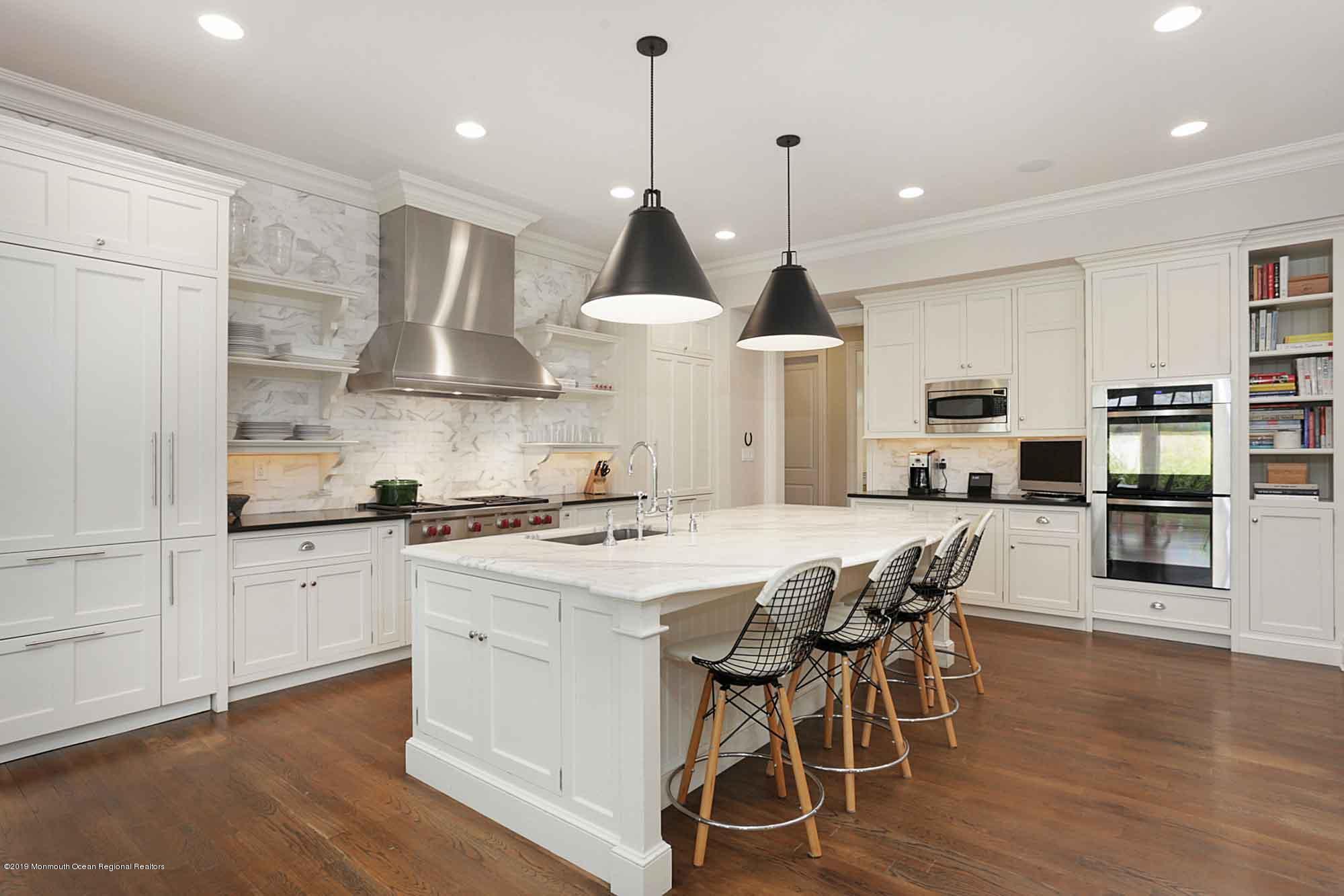 3 Sugar Maple Lane Rumson, NJ 07760 - Photo 12 of 33 a kitchen with stainless steel appliances a stove a table a sink and cabinets