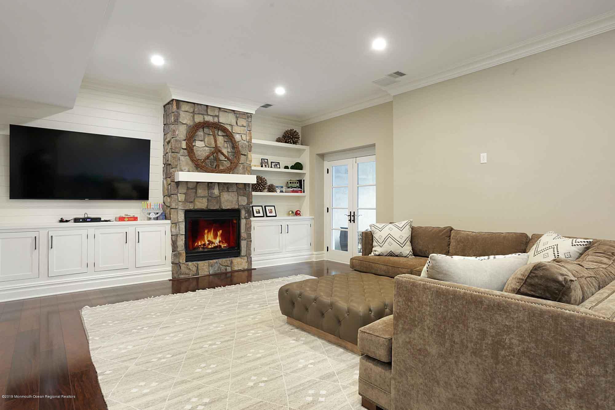 3 Sugar Maple Lane Rumson, NJ 07760 - Photo 21 of 33 a living room with furniture a flat screen tv and a fireplace