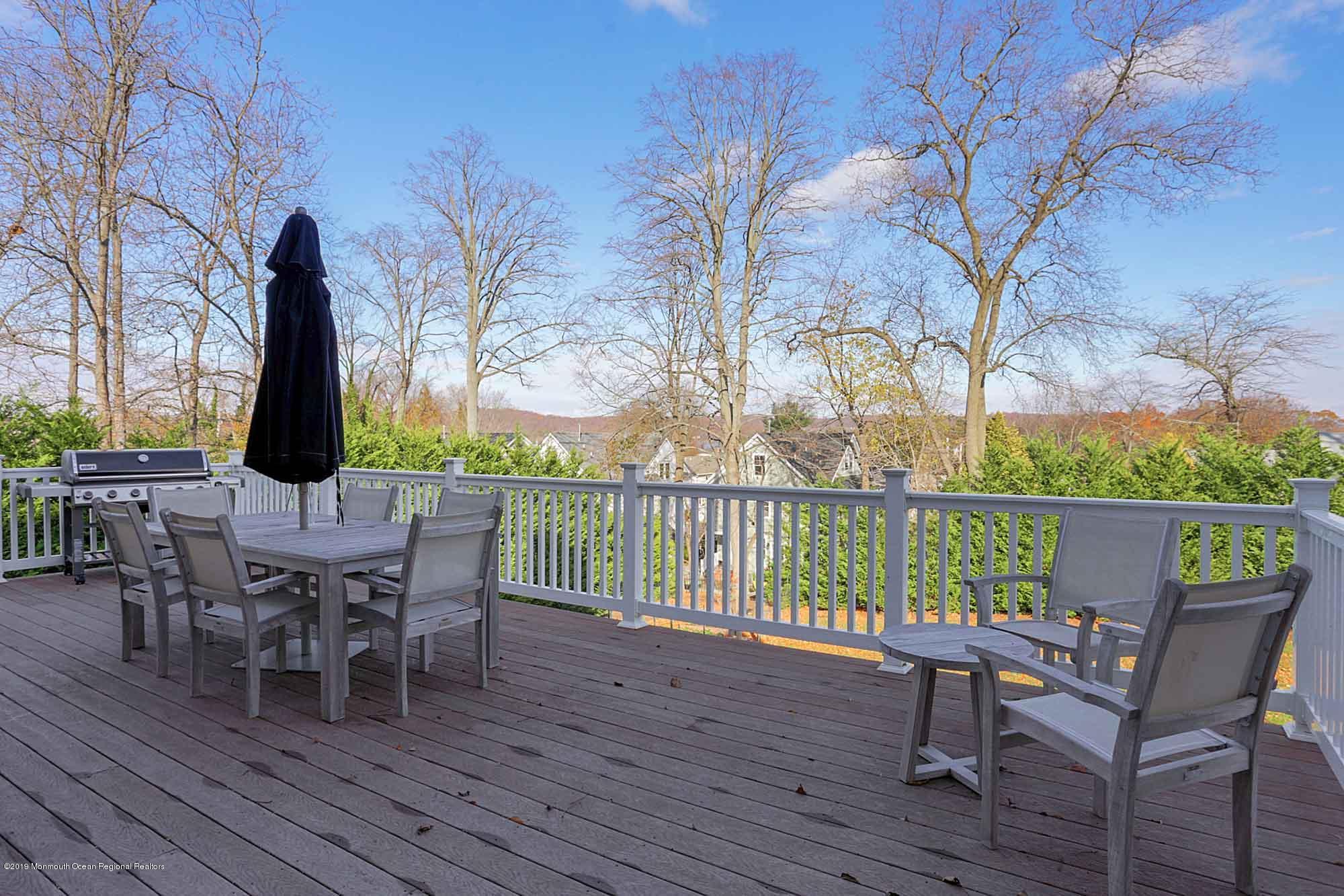 3 Sugar Maple Lane Rumson, NJ 07760 - Photo 27 of 33 a view of a deck with table and chairs and wooden floor