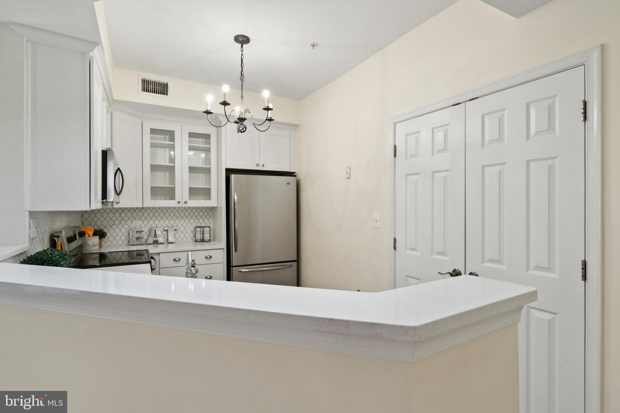 11313 Sundial Court, Unit 208 Reston, VA 20194 - Photo 13 of 30 Stone countertops plus a pantry in the kitchen
