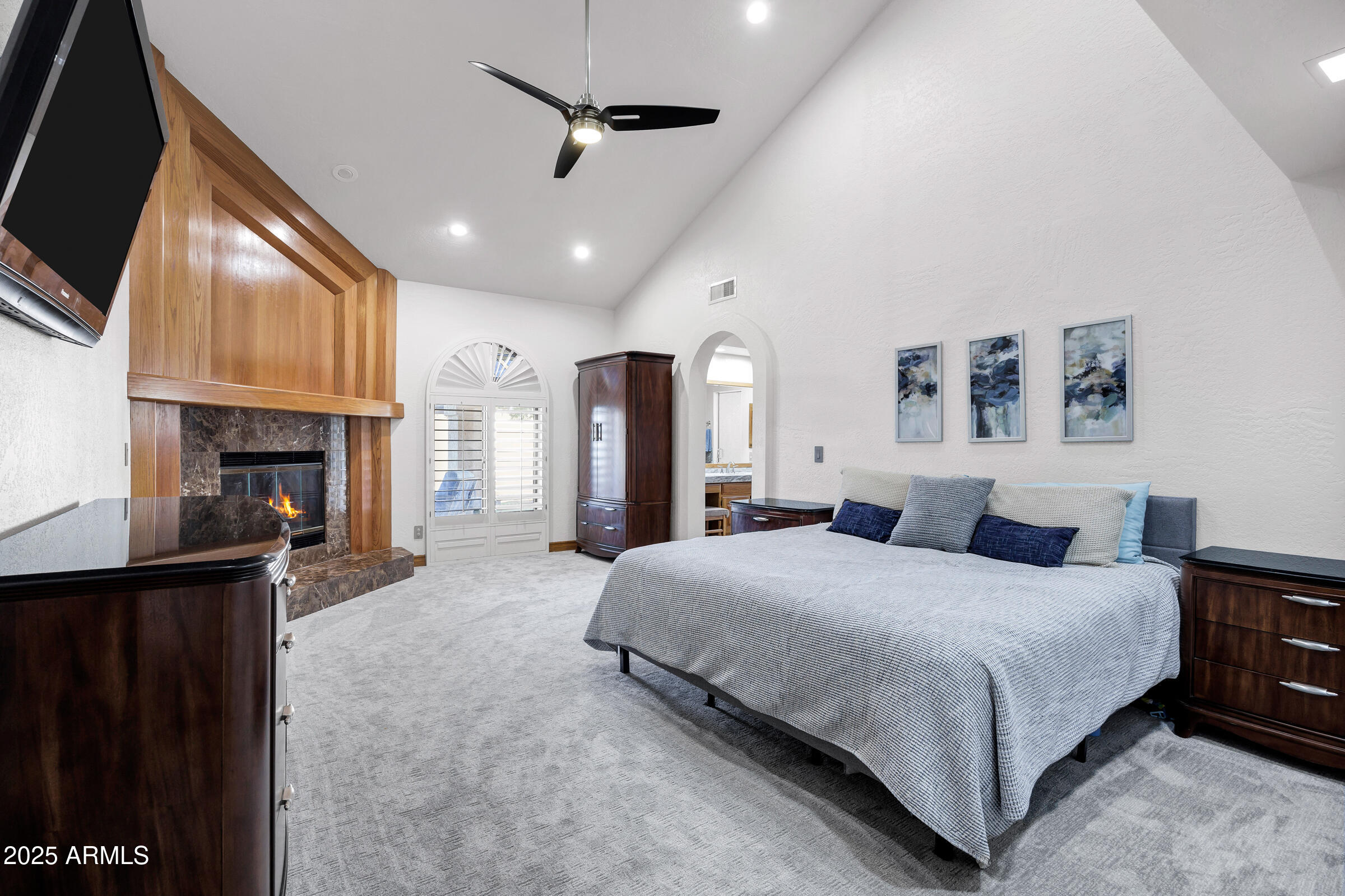 322 East Gary Circle Mesa, AZ 85201 - Photo 28 of 48 a bedroom with a large bed a flat tv screen and dresser