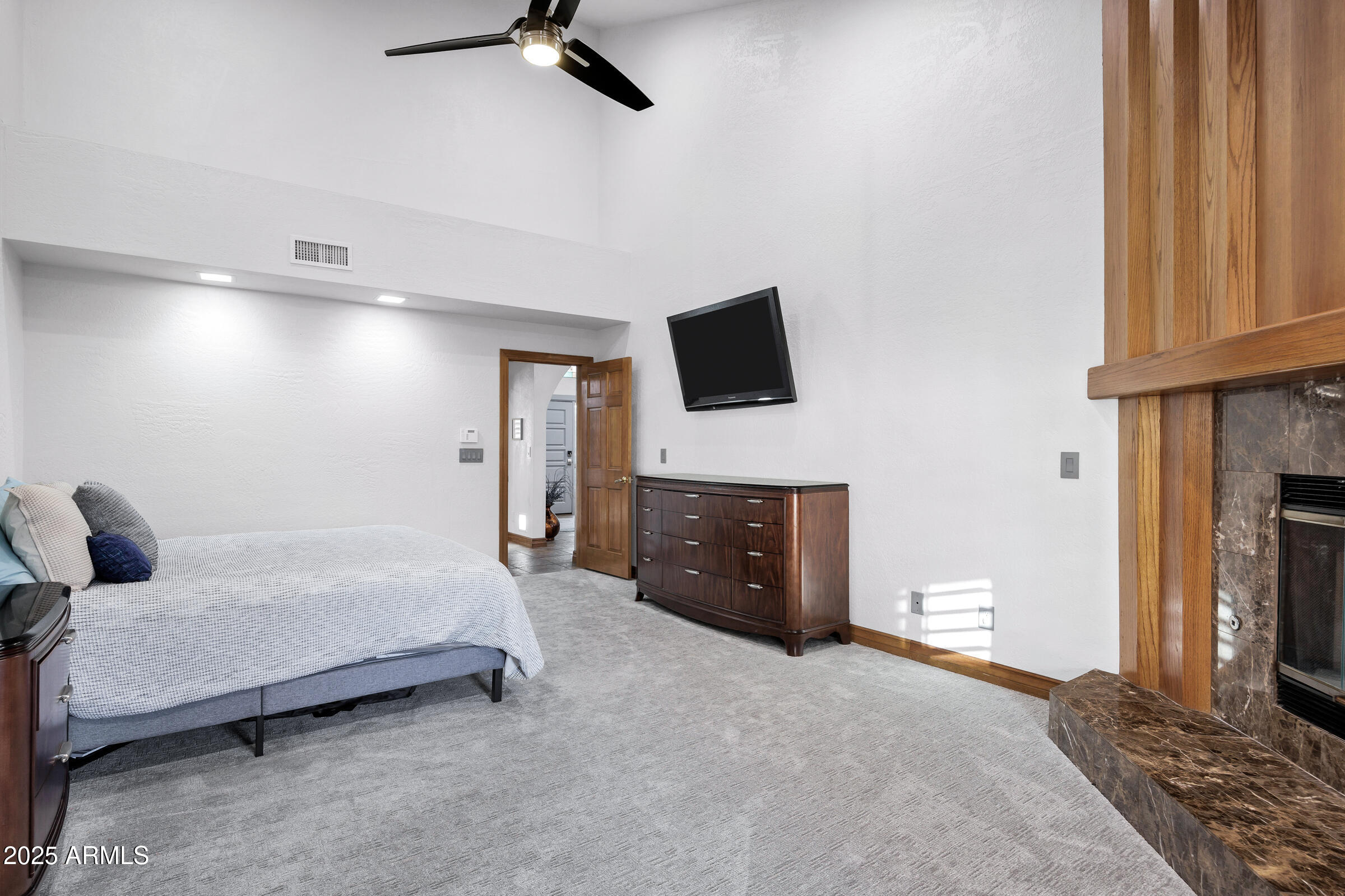 322 East Gary Circle Mesa, AZ 85201 - Photo 29 of 48 a spacious bedroom with a bed and a flat screen tv