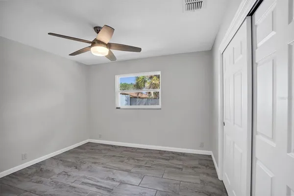 a view of empty room with wooden floor