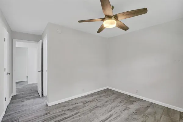 a view of empty room with wooden floor