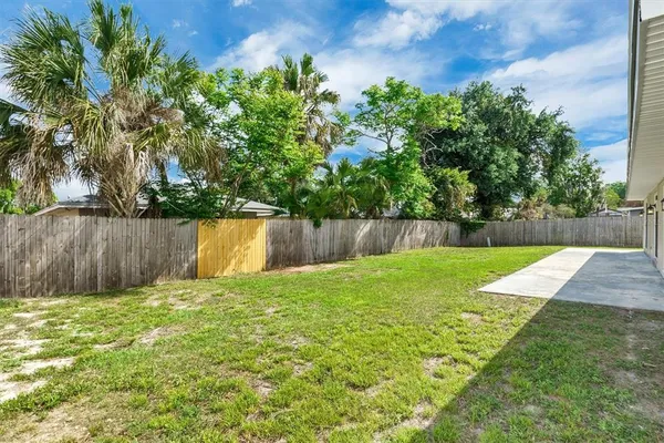 a view of a backyard with large trees