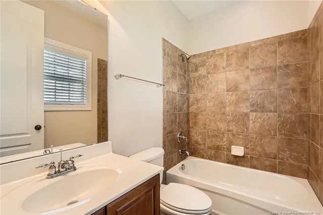 a bathroom with a sink a toilet and bathtub