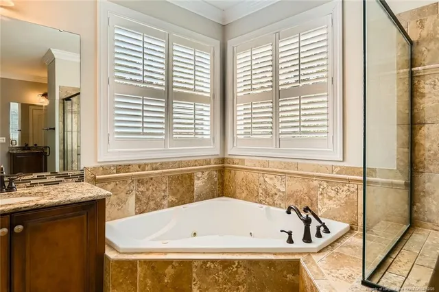a bathroom with a bathtub and next to a window