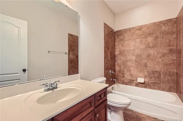 a bathroom with a sink a toilet and bathtub