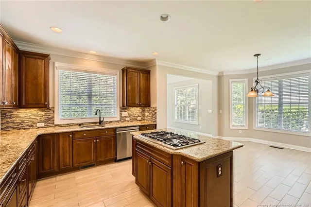 a kitchen with a stove sink and cabinets