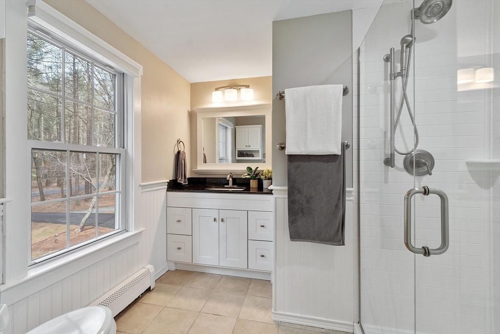 19 Green Needles Road Littleton, MA 01460 - Photo 22 of 42 a bathroom with a granite countertop sink a shower and a mirror