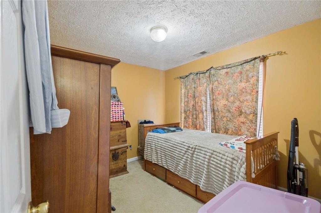 4220 Arrowhead Pointe Austell, GA 30106 - Photo 14 of 20 a bedroom with a bed and wooden floor