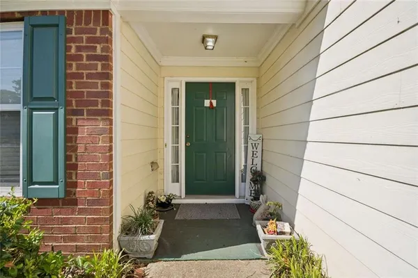 a front view of a house with a garden
