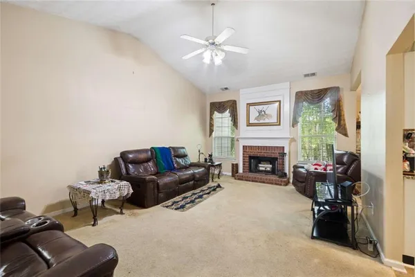 a living room with furniture and a fireplace
