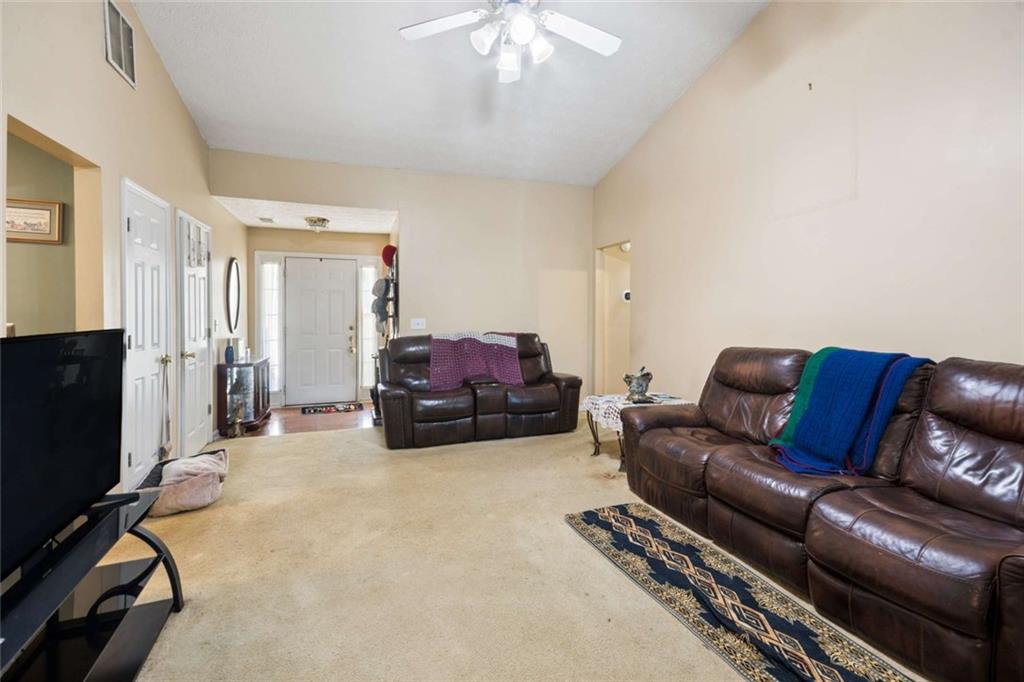 4220 Arrowhead Pointe Austell, GA 30106 - Photo 5 of 20 a living room with furniture a flat screen tv and gym equipment