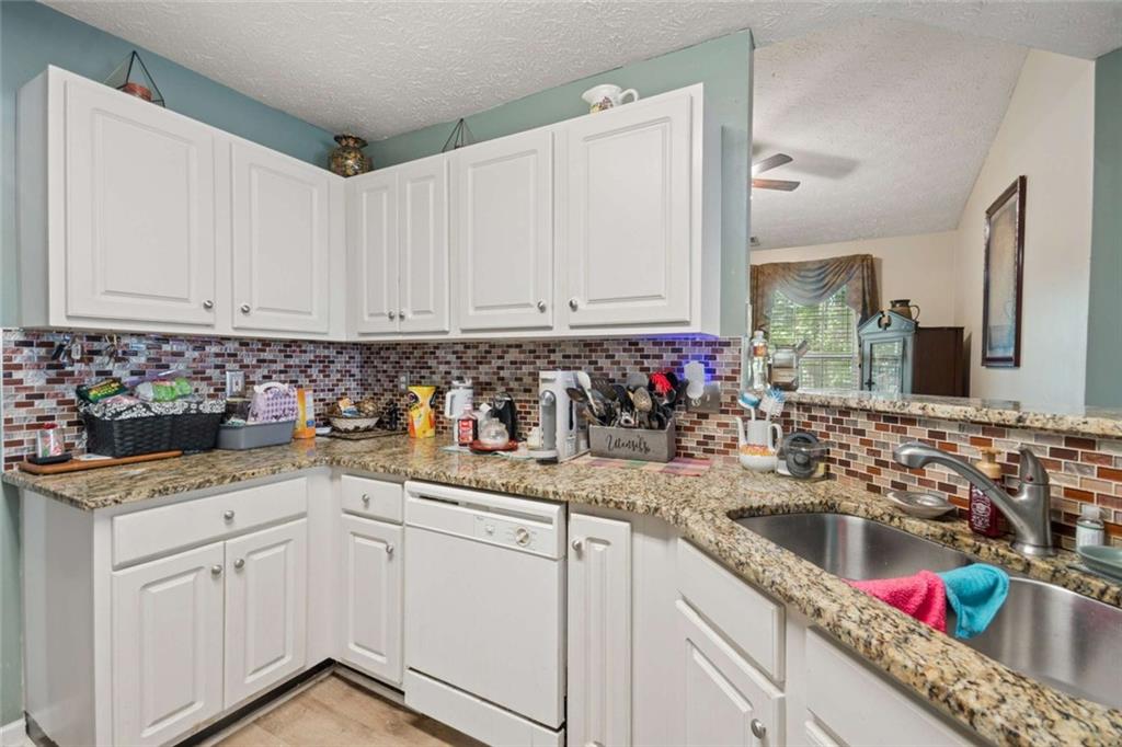 4220 Arrowhead Pointe Austell, GA 30106 - Photo 7 of 20 a kitchen with stainless steel appliances granite countertop a sink stove and cabinets