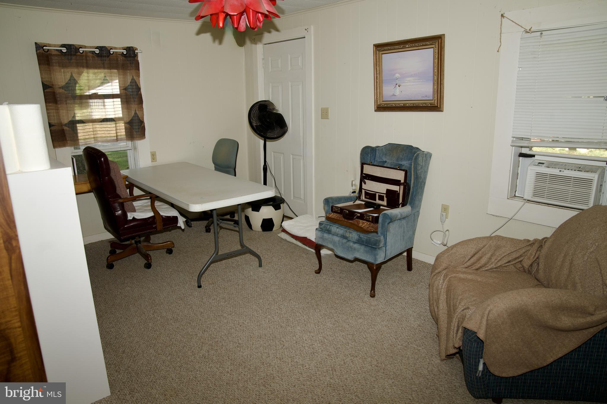 31867 Shavox Road Salisbury, MD 21804 - Photo 13 of 64 a living room with furniture and a chandelier