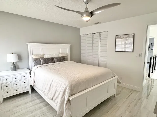 a bedroom with a bed and a night stand