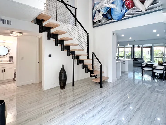 a view of entryway and hall with wooden floor