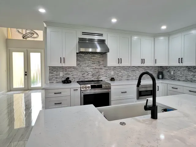 a kitchen with granite countertop a stove and a sink