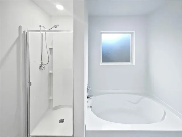 a bathroom with a tub shower vanity and a sink
