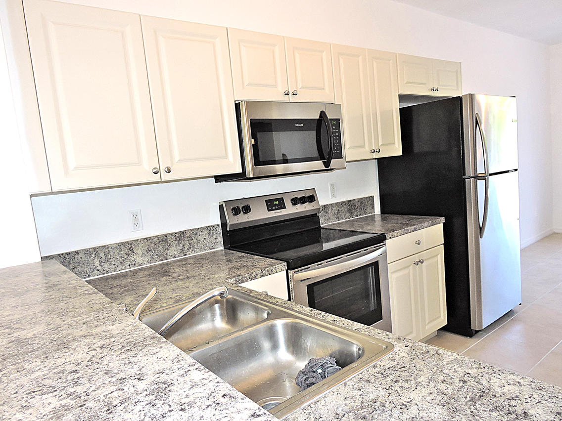 1986 Alamanda Way Riviera Beach, FL 33404 - Photo 12 of 49 a kitchen with a stove microwave and refrigerator