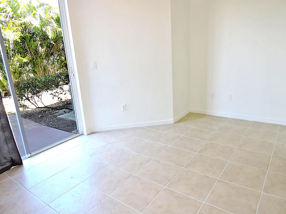 1986 Alamanda Way Riviera Beach, FL 33404 - Photo 17 of 49 a view of an empty room and floor to ceiling window
