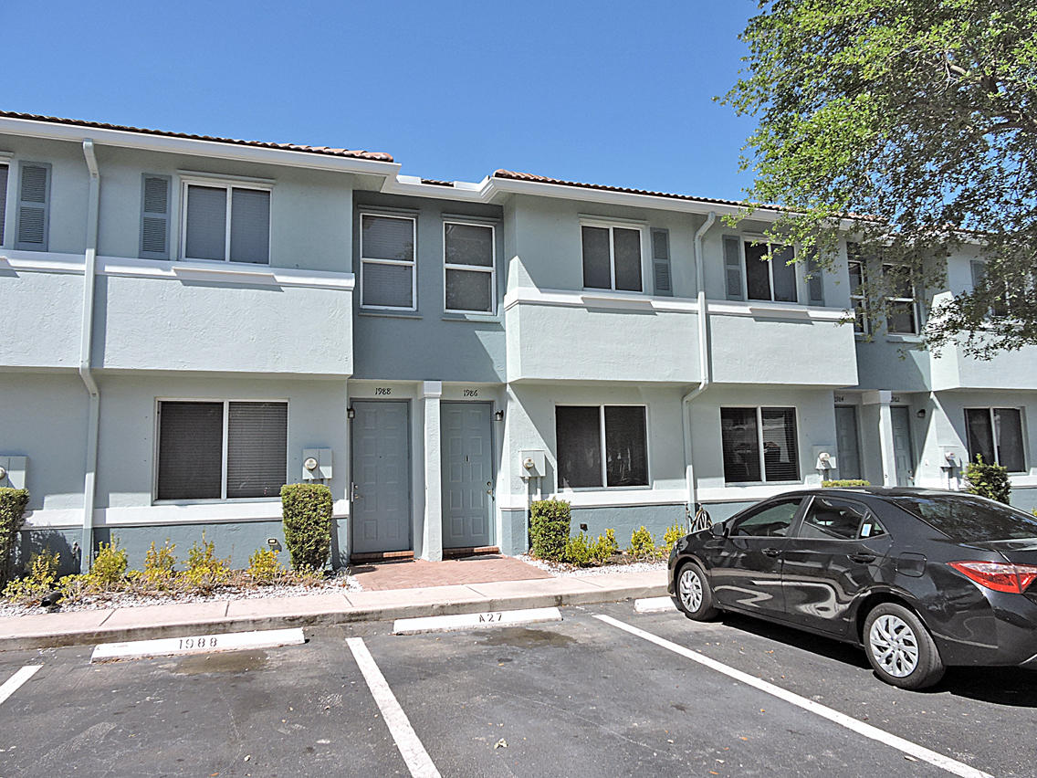 1986 Alamanda Way Riviera Beach, FL 33404 - Photo 2 of 49 a car parked in front of a house