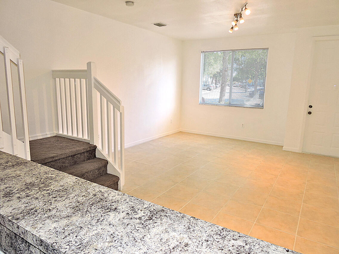 1986 Alamanda Way Riviera Beach, FL 33404 - Photo 26 of 49 a view of a bedroom with wooden floor and stairs