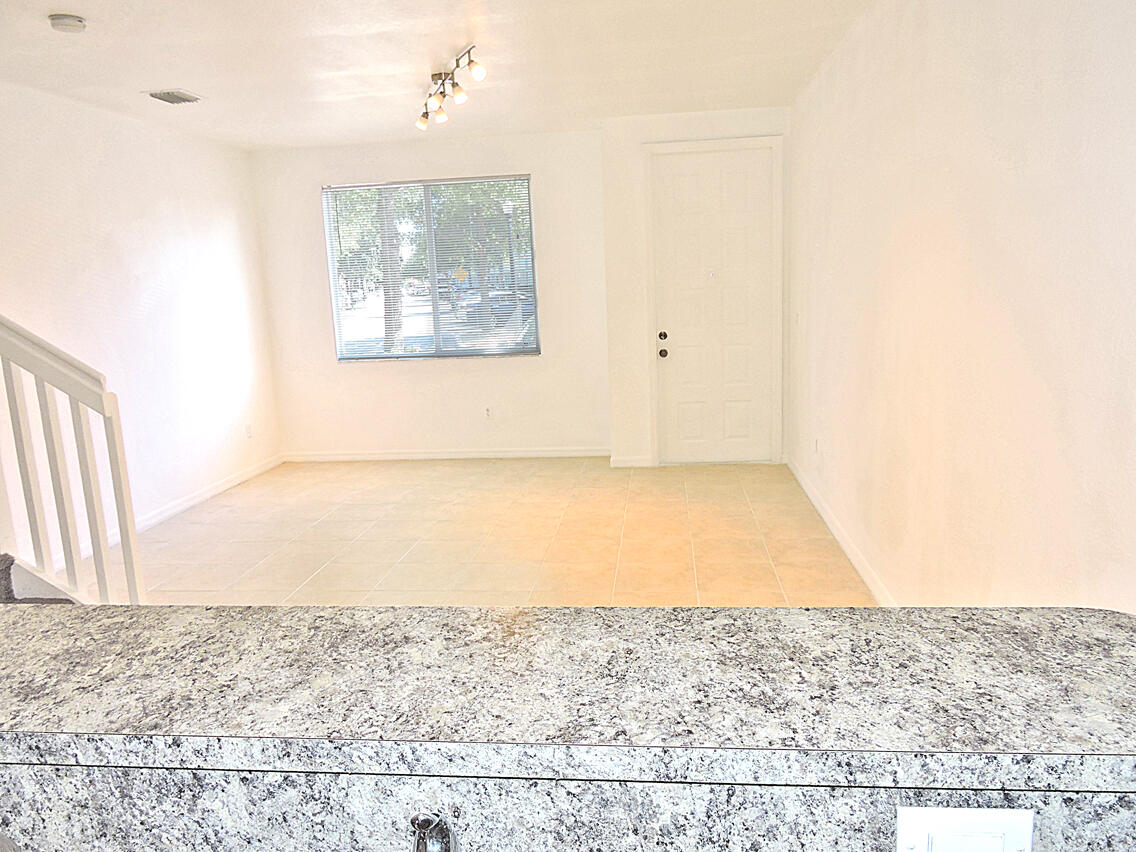 1986 Alamanda Way Riviera Beach, FL 33404 - Photo 27 of 49 an empty room with wooden floor