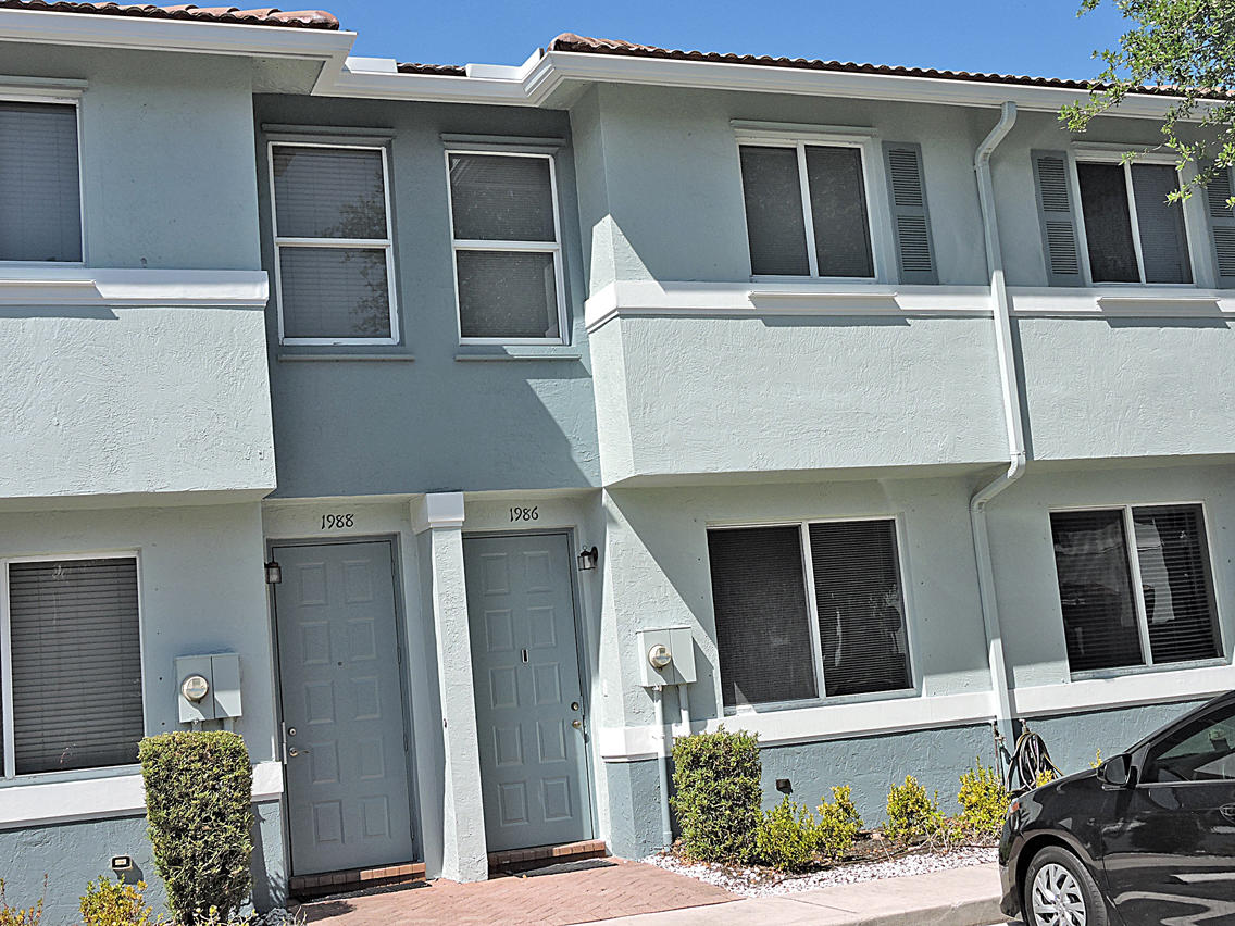 1986 Alamanda Way Riviera Beach, FL 33404 - Photo 3 of 49 a front view of a house with a yard