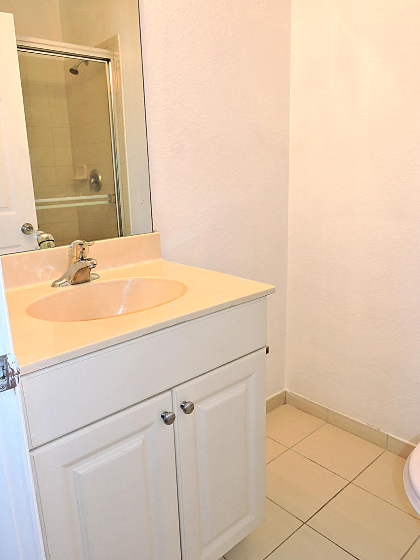 1986 Alamanda Way Riviera Beach, FL 33404 - Photo 34 of 49 a bathroom with a sink and a mirror