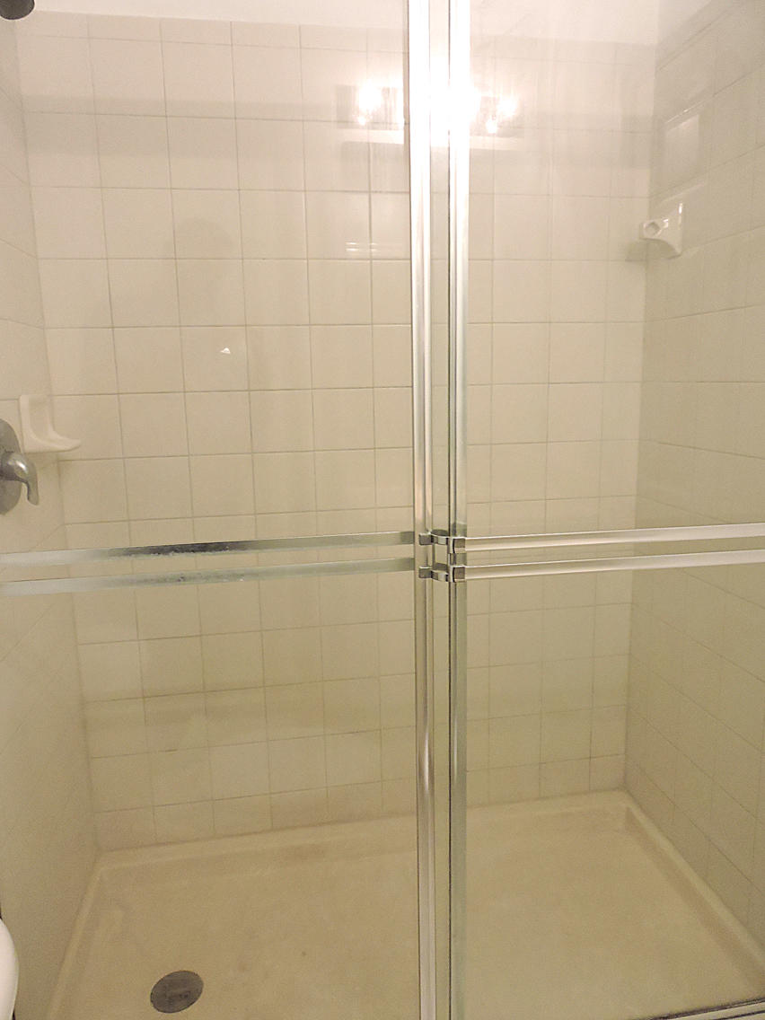 1986 Alamanda Way Riviera Beach, FL 33404 - Photo 36 of 49 a bathroom with a glass shower door