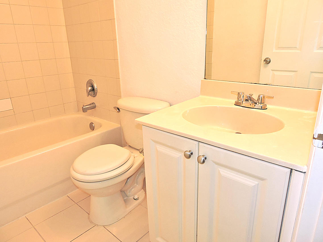 1986 Alamanda Way Riviera Beach, FL 33404 - Photo 38 of 49 a bathroom with a sink a toilet and bathtub