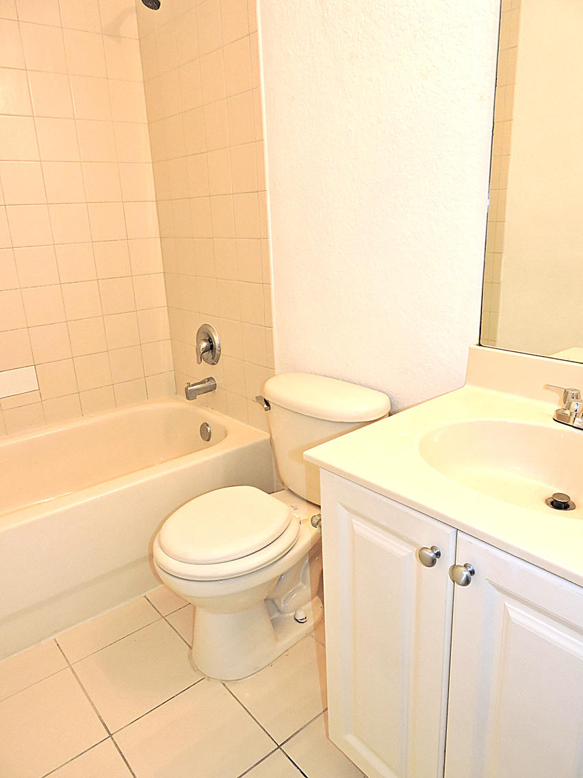 1986 Alamanda Way Riviera Beach, FL 33404 - Photo 39 of 49 a bathroom with a sink a toilet and bathtub