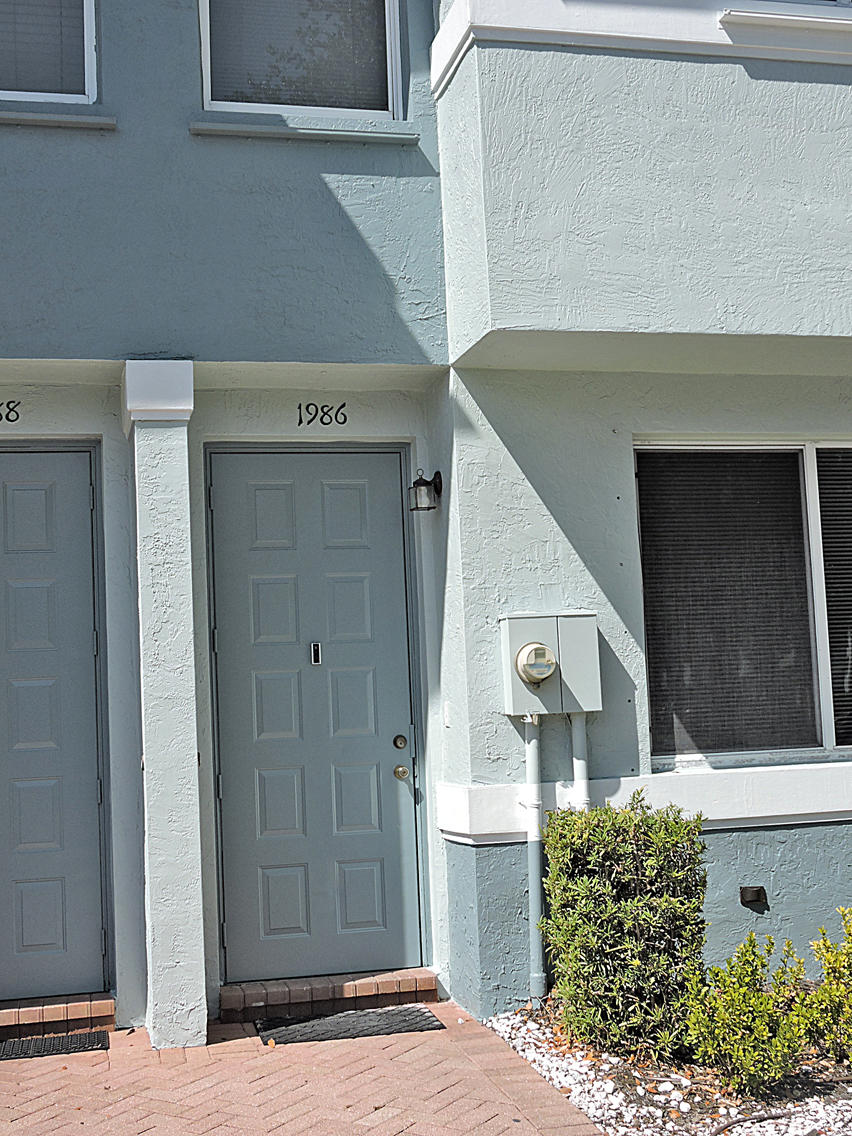 1986 Alamanda Way Riviera Beach, FL 33404 - Photo 4 of 49 a front view of a house with garden