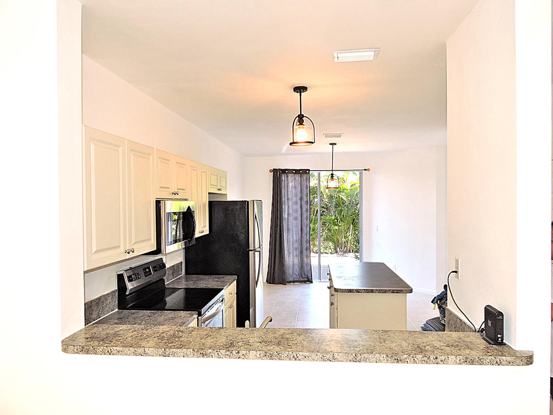 1986 Alamanda Way Riviera Beach, FL 33404 - Photo 9 of 49 a black and white photo of a living room