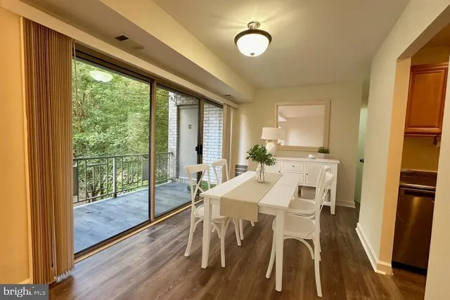 a view of a dining room with furniture window and wooden floor