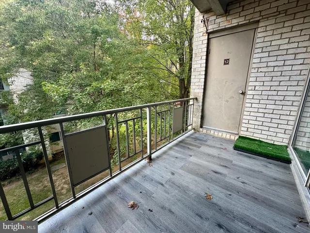 a view of balcony with wooden floor