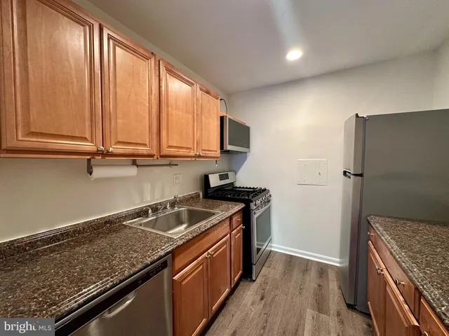 a kitchen that has a sink a stove and a window