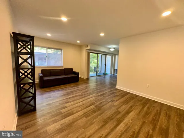 a view of an empty room and wooden floor