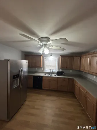 a large kitchen with a large counter top appliances and cabinets