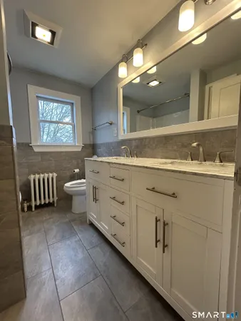 a bathroom with a sink a mirror and a bathtub