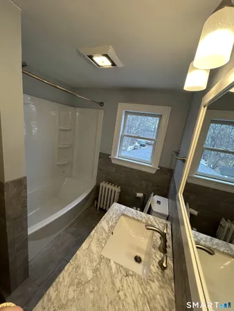 a bathroom with a tub and shower