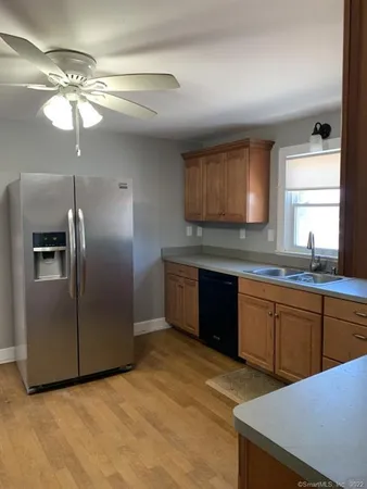 a kitchen with stainless steel appliances granite countertop a sink a stove a refrigerator and island